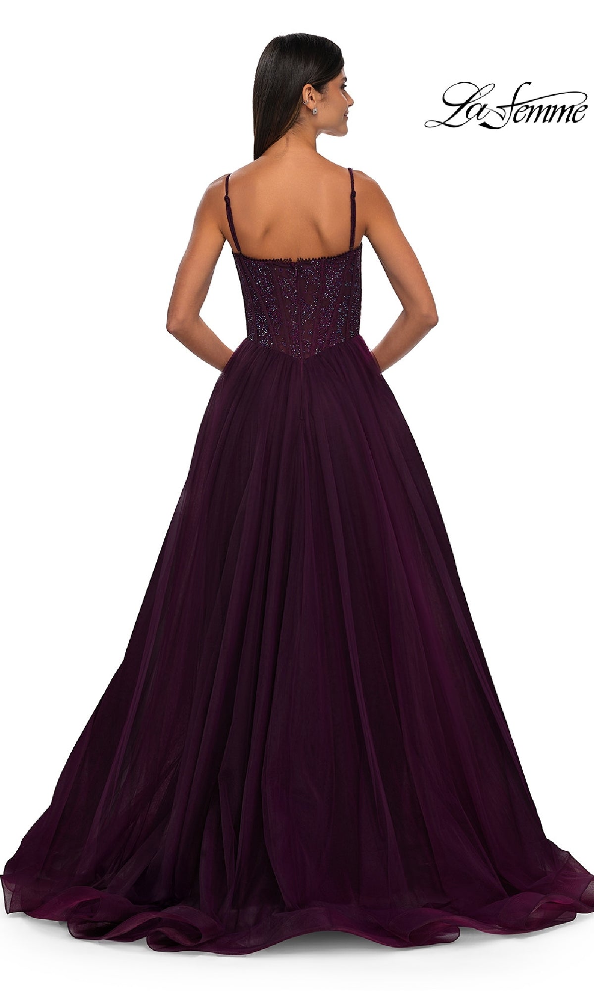 A woman faces away, wearing the floor-length Beaded-Bodice Long Prom Ball Gown La Femme 32594 in deep purple with thin straps and a fitted, embellished bodice. The background is white with the La Femme logo in the top right corner.